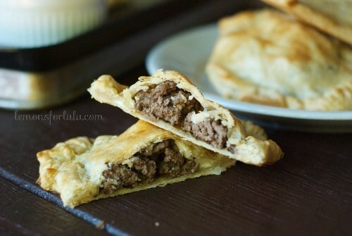 A savory hand pie filled with Greek flavored ground beef. Simple to put together as it starts with a pre made crust! www.lemonsforlulu.com