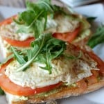 A homemade edamame spread is slathered on a ciabatta bread. White cheddar, veggies and a fried egg rests right on top! www.lemonsforlulu.com