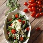 A simple green bean salad with cherry tomaotes, feta and a tarragon vinaigrette! www.lemonsforlulu.com