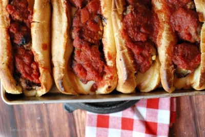 Skip the sandwich shop and make meatball subs at home! These meatballs are baked with two kinds of meat and smothered in a simple homemade sauce! www.lemonsforlulu.com