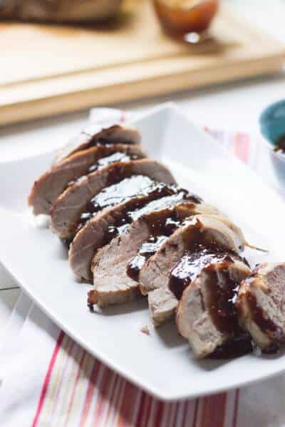 Oven roasted pork tenderloin is served with a tangy, sweet balsamic fig sauce! lemonsforlulu.com