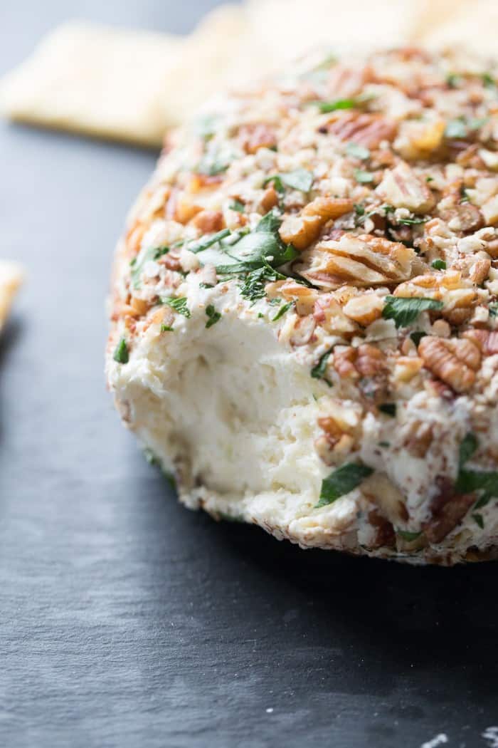 This easy cheese ball is crazy good! Roasted garlic and three kinds of cheese make this creamy appetizer positively addicting! lemonsforlulu.com