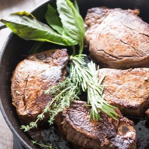 Beef tenderloin steak recipe served with thick portobello slices and fresh herb butter! lemonsforlulu.com
