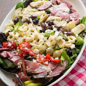 This Italian chopped salad is bursting at the seams! It is loaded with meats, cheese, veggies and pasta and boasts a creamy Italian dressing!