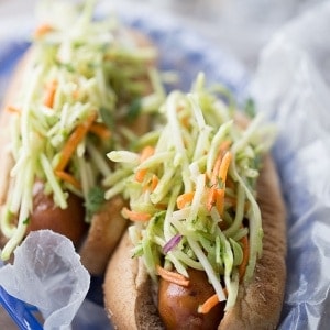 A spicy broccoli slaw tops these easy grilled chicken sausages. lemonsforlulu.com