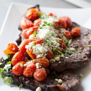 Simple grilled steak with roasted tomatoes and blue cheese. lemonsforlulu.com
