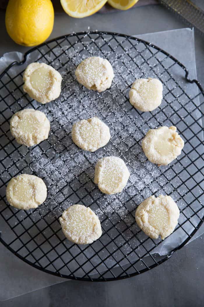 These lemon cookies are crisp and buttery; perfect as is! But top these cookies with a white chocolate ganache and you have something amazing! lemon cookies on a cooling rack