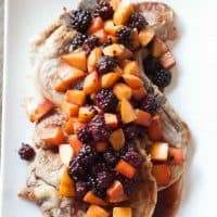 Pork chops couldn’t be tastier than this version smothered in a fresh blackberry peach sauce! www.lemonsforlulu.com