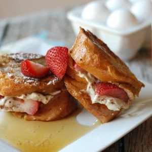 Thick french bread stuffed with fresh strawberries and sweeteend cream cheese for the best french toast ever! www.lemonsforlulu.com
