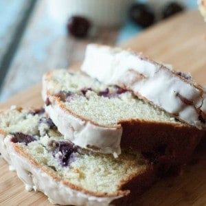 This quick bread is made with fresh pitted cherries and has a hint of almond throughout. A simple vanilla almond glaze is drizzled on top! www.lemonsforlulu.com