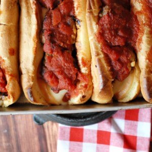 Skip the sandwich shop and make meatball subs at home! These meatballs are baked with two kinds of meat and smothered in a simple homemade sauce! www.lemonsforlulu.com
