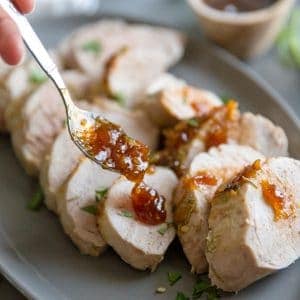oven roasted pork tenderloin fig sauce being served