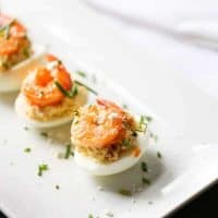 These Buffalo shrimp deviled eggs will be a hit wherever they go! The spicy shrimp are tamed by the tang blue cheese filling. Time to rethink the way you do deviled eggs! #OhioEggRoll