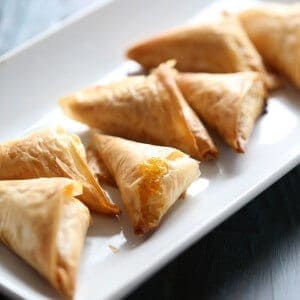 Flakey filo dough is wrapped around cream cheese, pistachios and apricot preserves. Not your ordinary appetizer! lemonsforlulu.com
