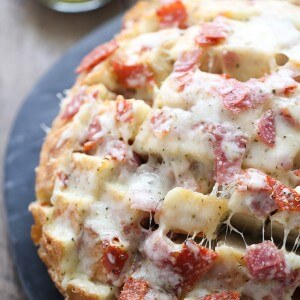 Crusty bread is stuffed full of cheese, and deli meats. This pull apart bread has everything you love about hoagies in one gooey, cheesy, appetizer! lemonsforlulu.com