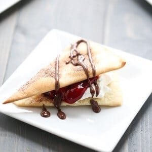 Raspberry pie filling stacked between flaky pie dough, whipped cream and a drizzle of chocolate. lemonsforlulu.com