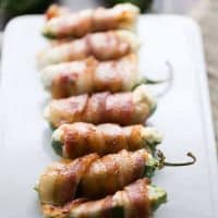 Sweet and smokey bacon is wrapped around a cheese stuffed jalapeño! lemonsforlulu.com #SplendaSweetie #SweetSwap