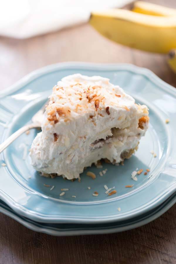 Coconut Banana Cream Pie Recipe - Thick coconut infused custard layered between roasted bananas and resting in a graham cracker crust! lemonsforlulu.com