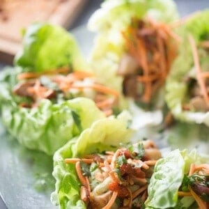 Soy ginger chicken, tender mushrooms, cool cucumbers, crisp carrots and spicy almonds are tucked inside these chicken lettuce wraps. The perfect hand held meal! LemonsForLulu.com
