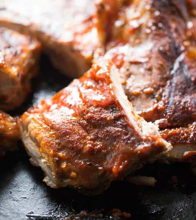 An easy bbq rib recipe that starts in the even, but ends on the grill! These baby back ribs are dry rubbed then basted with a spicy/sweet bbq sauce! lemonsforlulu.com