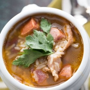 Red beans and rice are mixed with bacon and andouille sausage for flavorful and filling soup recipe! lemonsforlulu.com