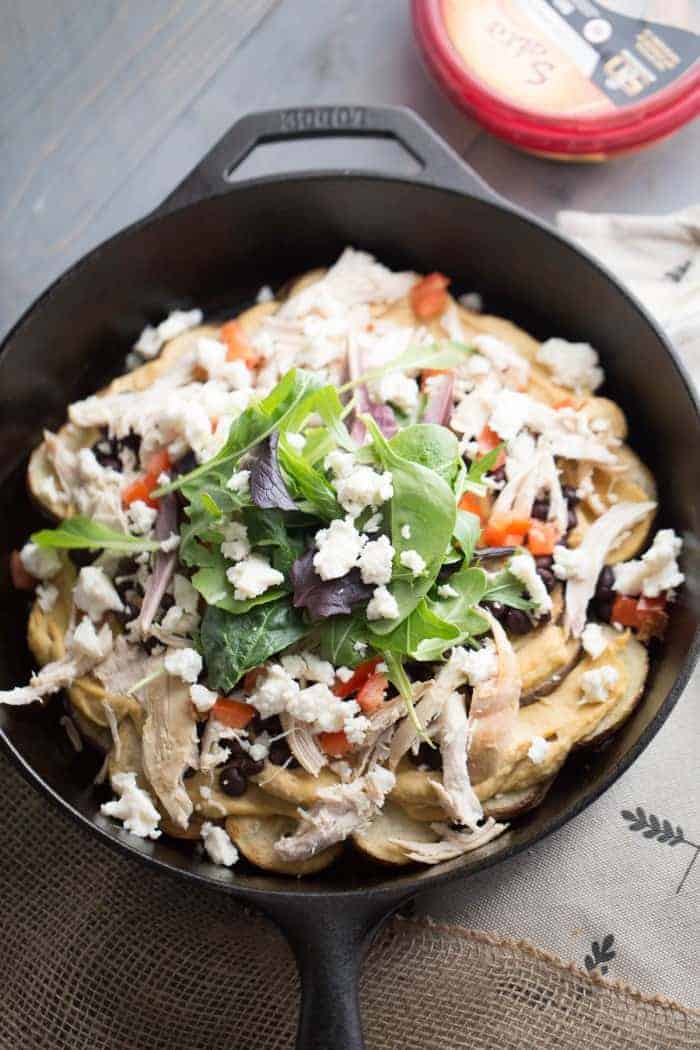 Nachos with a light twist! Hummus, black beans, chicken and veggies make these Irish nachos an irreistibly good game day snack! lemonsforlulu.com