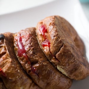 Strawberry stuffed croissant French toast drizzled with a little sweetned condensed milk; Cuban style!