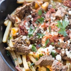 This easy poutine recipe has slow cooked brisket, bacon and two kinds of cheese !
