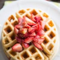 This easy homemade waffles recipe gets a tangy kick from key lime and is served with a sweet strawberry topping.