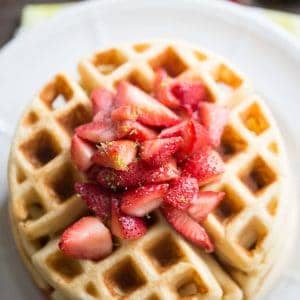 This easy homemade waffles recipe gets a tangy kick from key lime and is served with a sweet strawberry topping.