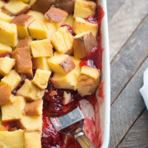 Strawberry rhubarb pie filling is topped with pound cake and baked in a custard sauce. A vanilla glaze is drizzled over top this easy dessert recipe!