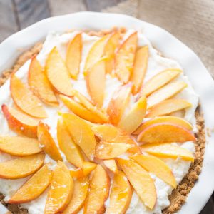 This fresh peach pie is easy, creamy and delicious! This crown pleasing pie has a shortbread crust, a fluffy mascarpone filling and lots of fresh peaches on top!