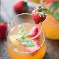 This mango sangria is so refreshing! Sweet mangos and strawberries are combined with a light wine and vodka to bring you a little taste of summer in a glass!