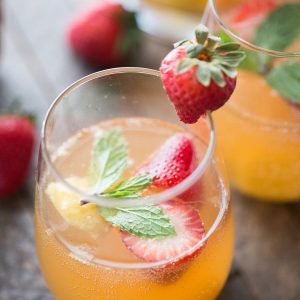 This mango sangria is so refreshing! Sweet mangos and strawberries are combined with a light wine and vodka to bring you a little taste of summer in a glass!