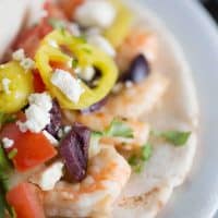 This gyro sandwich is a little different. Creamy, garlic shrimp is placed inside pita rounds them topped with fresh vegetables, feta and a homemade tzatziki sauce!