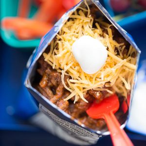 BBQ beef makes lunch fun! A saucy beef mixture is spooned over ranch-flavored chips and then topped with your favorite taco fixings!