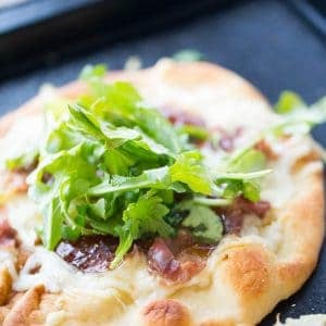 Naan bread is topped with creamy fontina cheese, salty prosciutto and sweet fig jam for this Naan Pizza recipe. | lemonsforlulu.com