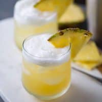 Pineapple Bourbon Punch - Bourbon, sweet pineapple juice, and hazelnut liqueur are shaken together for a tropical tasting drink.