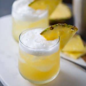 Pineapple Bourbon Punch - Bourbon, sweet pineapple juice, and hazelnut liqueur are shaken together for a tropical tasting drink.