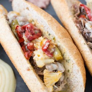 Nothing beats a good cheesesteak sandwich! This Italian version has pickled vegetables, roasted red peppers, provolone and a hummus garlic herb spread!