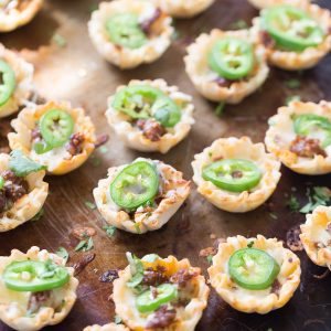 Simple queso funded bites will make your party! These cheesy two-bite snacks are made with a handful of ingredients and come together quickly!