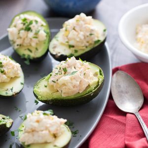 This deviled avocado takes deviled eggs to a whole new level! Seasoned egg salad is nestled into the center of avocados for a light lunch or snack!