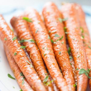 Oven roasted carrots coated in garlic and parsley are simple and delicious! You are going to love them!