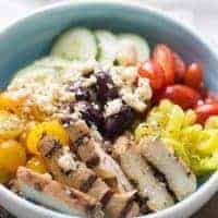 Mediterranean chicken bowl with lots of fresh veggies and healthy farrow! This dish cannot be beat!