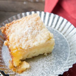 This tender crumb cake is so fluffy and moist! It has a tart lemon curd layer and a buttery crumb topping!