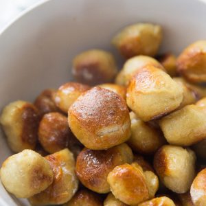 Soft pretzel bites are coated in melted butter and ranch seasoning for the perfect snack! Don't forget he Buffalo sauce!