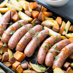 This sheet pan sausage dinner is inspired by the flavors of fall. Cheesy sausage is baked along side sweet potatoes, apples and a simple apricot glaze!