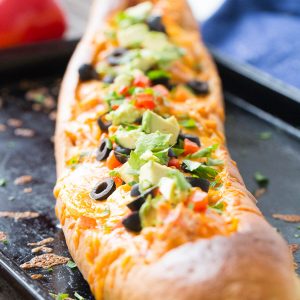 This chicken enchilada bread makes dinner simple! Chicken and sauce are stuffed inside French bread and baked! You decide on the toppings!