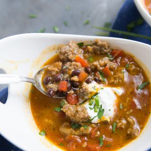 This black bean chili has a little something special; pumpkin! This easy chili is filled with black beans, Italian sausage, spices, and pumpkin. This filling black bean chili is just what you need when you need a little warming!
