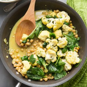 It's easy going meatless with this easy Vegetarian Curry. Cauliflower, garbanzo beans, and spinach are cooked in a coconut sauce that is rich and silky!